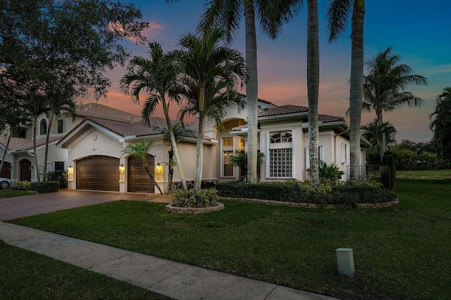 8837 Woodgrove Ridge Ct, Boynton Beach, FL 33473 - mediterranean / spanish-style home featuring driveway, a tile roof, a front yard, a garage, and stucco siding