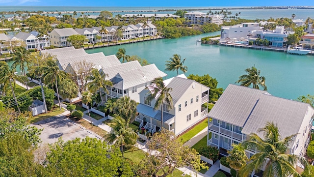 drone / aerial view featuring a water view and a residential view
