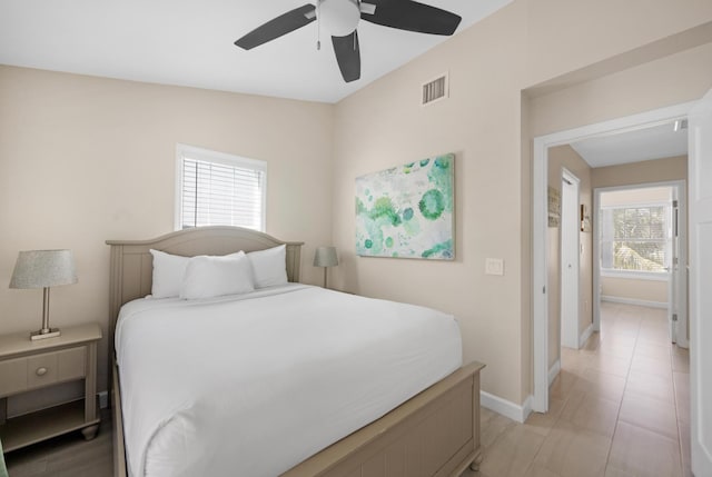 bedroom with baseboards, a ceiling fan, and visible vents