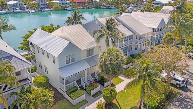 birds eye view of property with a water view and a residential view