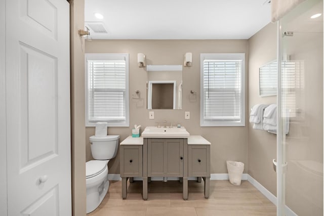 full bathroom with baseboards, an enclosed shower, toilet, and vanity