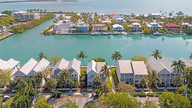 birds eye view of property with a water view and a residential view