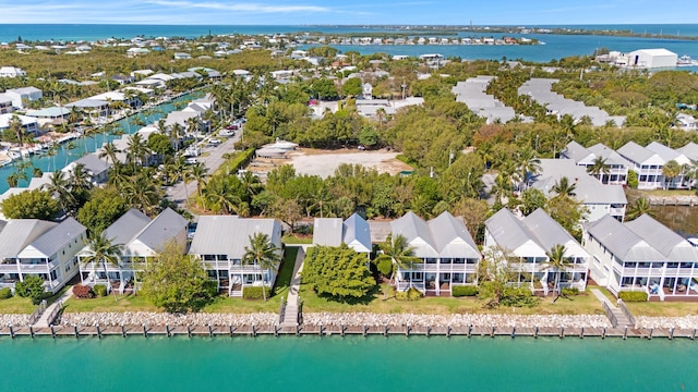 drone / aerial view featuring a residential view and a water view