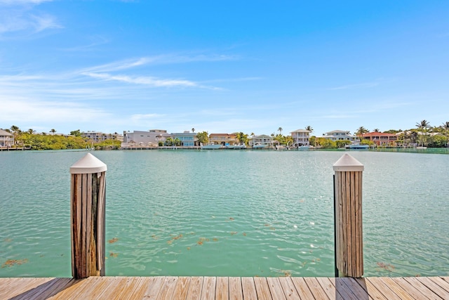 dock area with a residential view and a water view