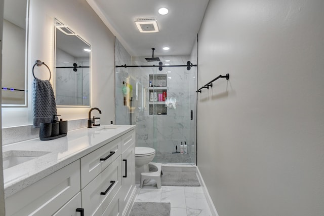 bathroom featuring a sink, baseboards, toilet, marble finish floor, and a marble finish shower