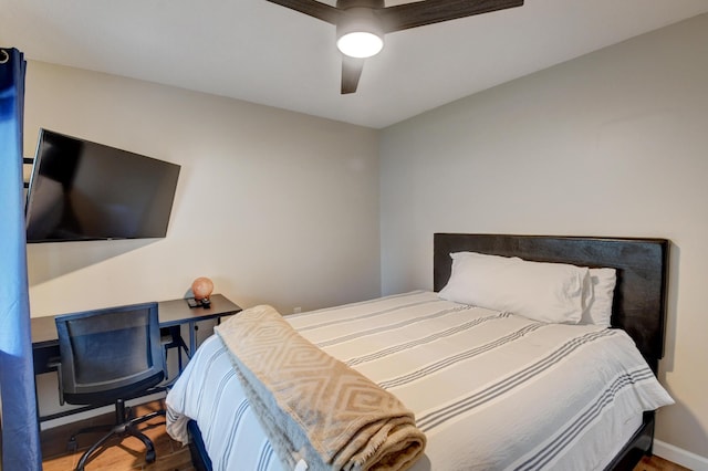 bedroom with baseboards, ceiling fan, and wood finished floors
