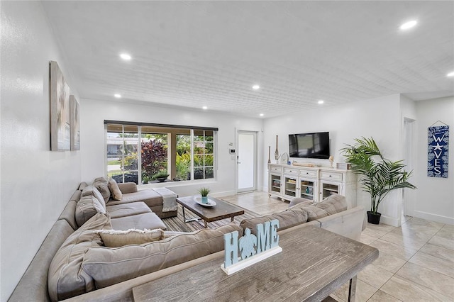 living room with light tile patterned floors, baseboards, and recessed lighting