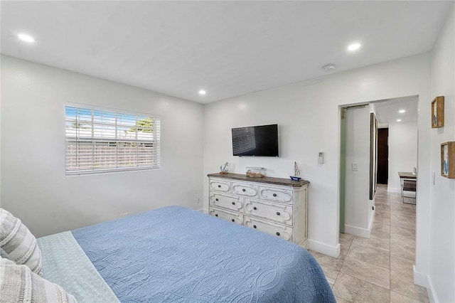 bedroom featuring light tile patterned floors, baseboards, and recessed lighting