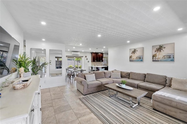 living area featuring baseboards, recessed lighting, and a wall mounted air conditioner