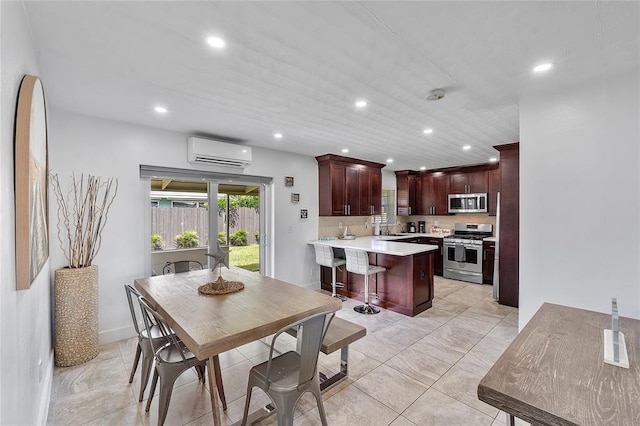dining room featuring recessed lighting and a wall mounted air conditioner