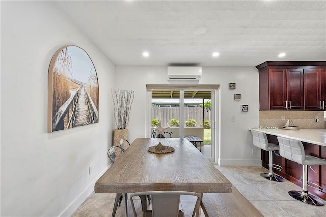 dining space with recessed lighting, a wall mounted air conditioner, baseboards, and light tile patterned flooring