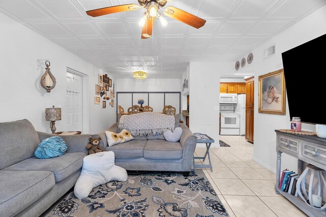712 Sunny Pine Way Unit D1, Greenacres, FL 33415 - living area featuring visible vents, ceiling fan, light tile patterned floors, and an ornate ceiling