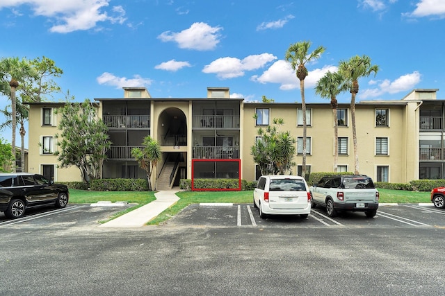 712 Sunny Pine Way Unit D1, Greenacres, FL 33415 - view of property with stairs and uncovered parking
