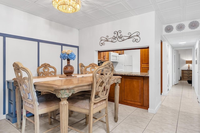 712 Sunny Pine Way Unit D1, Greenacres, FL 33415 - dining space with light tile patterned floors, an ornate ceiling, and an inviting chandelier