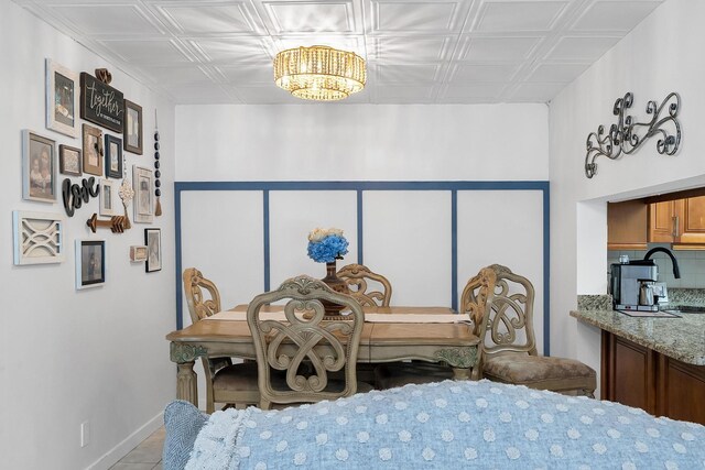 712 Sunny Pine Way Unit D1, Greenacres, FL 33415 - tiled dining area with an ornate ceiling, baseboards, and a notable chandelier