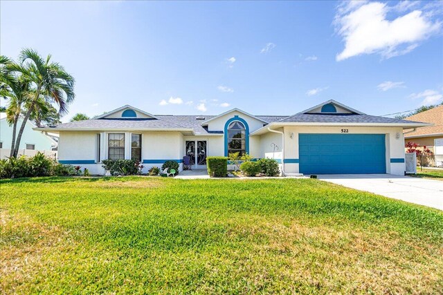 522 SE Majestic Ter, Port Saint Lucie, FL 34953 - ranch-style house with an attached garage, stucco siding, driveway, and a front yard