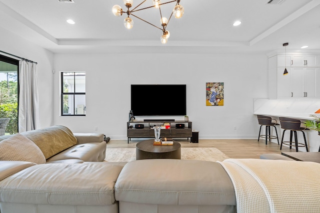 13158 Artisan Cir, Palm Beach Gardens, FL 33418 - living room with a raised ceiling, light wood-style flooring, recessed lighting, and a chandelier