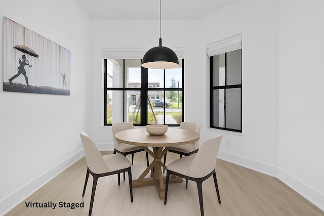 13158 Artisan Cir, Palm Beach Gardens, FL 33418 - dining area with light wood-style flooring and baseboards