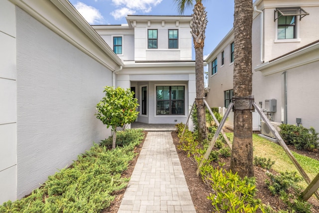 13158 Artisan Cir, Palm Beach Gardens, FL 33418 - entrance to property featuring stucco siding and a cooling unit