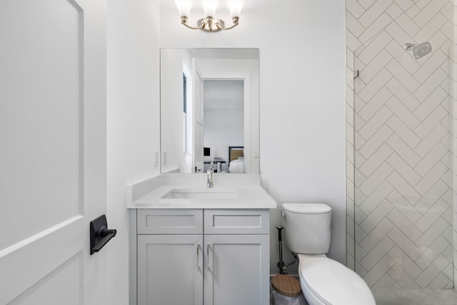 13158 Artisan Cir, Palm Beach Gardens, FL 33418 - full bathroom featuring vanity, toilet, a tile shower, and a chandelier