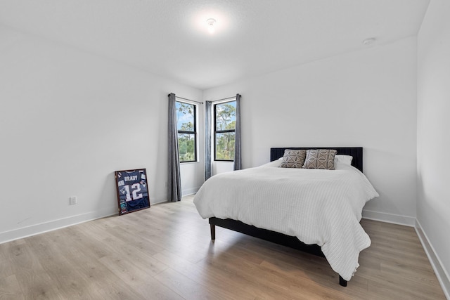 13158 Artisan Cir, Palm Beach Gardens, FL 33418 - bedroom with light wood-style floors and baseboards