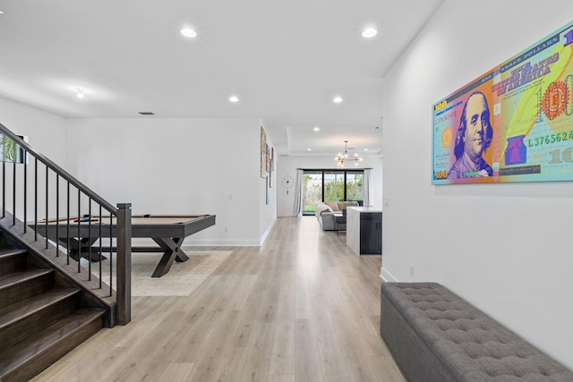 13158 Artisan Cir, Palm Beach Gardens, FL 33418 - hall featuring recessed lighting, stairway, a chandelier, light wood finished floors, and baseboards