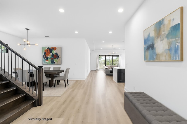 13158 Artisan Cir, Palm Beach Gardens, FL 33418 - hallway featuring a chandelier, stairway, recessed lighting, and light wood finished floors