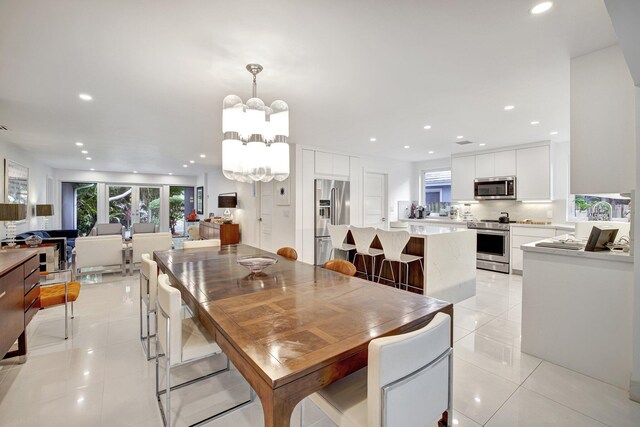 dining room with light tile patterned flooring, recessed lighting, and an inviting chandelier