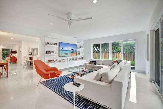 living area with a ceiling fan, recessed lighting, and light tile patterned flooring