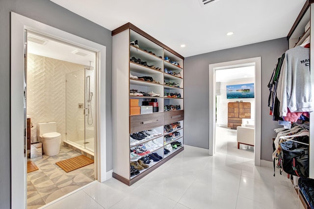 spacious closet with light tile patterned floors