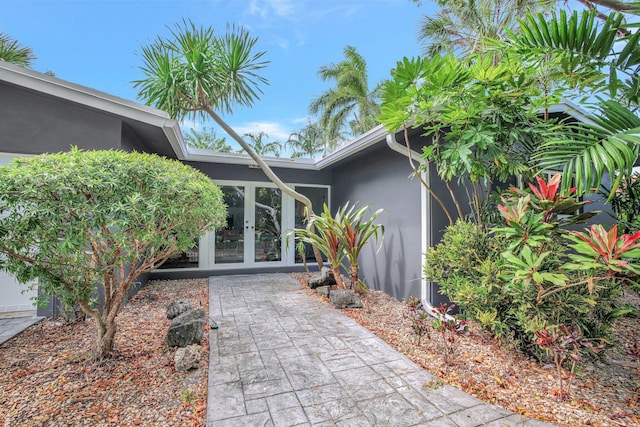 entrance to property with french doors and stucco siding