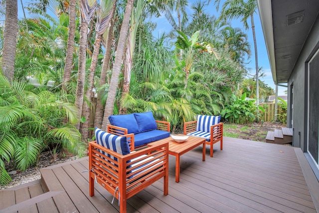 deck with an outdoor living space and fence