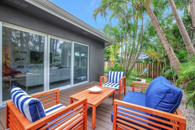 deck with an outdoor living space and fence