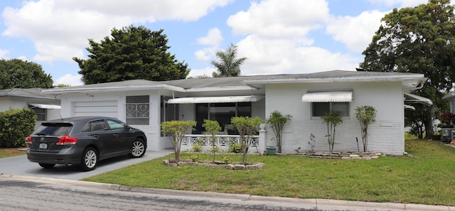 1020 NW 74th Ave, Margate, FL 33063 - view of front of property with a porch, an attached garage, driveway, and a front yard