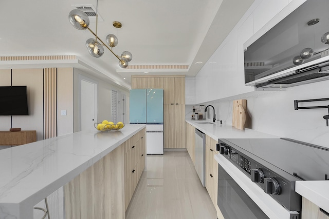 928 Market St, West Palm Beach, FL 33401 - kitchen featuring light brown cabinets, modern cabinets, freestanding refrigerator, stainless steel dishwasher, and range with electric stovetop