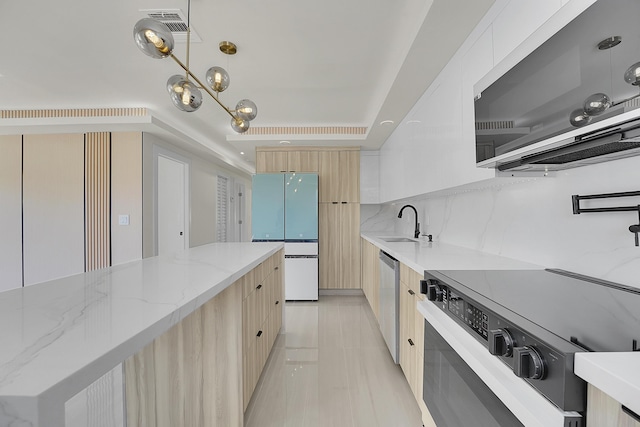 928 Market St, West Palm Beach, FL 33401 - kitchen featuring light stone countertops, appliances with stainless steel finishes, light brown cabinets, light tile patterned floors, and modern cabinets