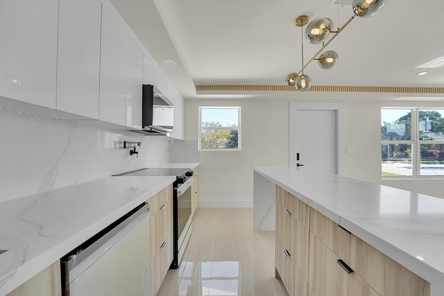 928 Market St, West Palm Beach, FL 33401 - kitchen featuring white dishwasher, light stone counters, modern cabinets, and electric range oven