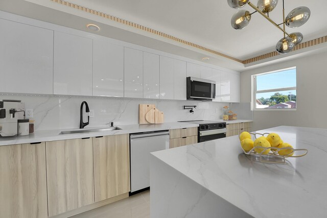 928 Market St, West Palm Beach, FL 33401 - kitchen featuring a sink, dishwasher, range with electric cooktop, stainless steel microwave, and modern cabinets