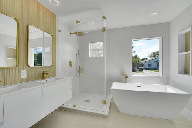 928 Market St, West Palm Beach, FL 33401 - full bathroom with double vanity, a freestanding tub, tile patterned floors, a shower stall, and a sink