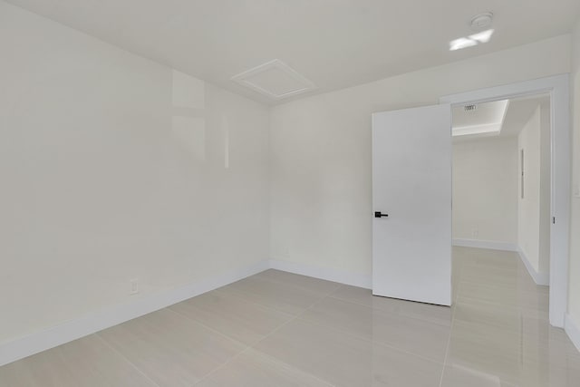 928 Market St, West Palm Beach, FL 33401 - spare room featuring baseboards, attic access, light tile patterned floors, and visible vents