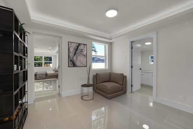 928 Market St, West Palm Beach, FL 33401 - sitting room with baseboards, tile patterned floors, and a tray ceiling