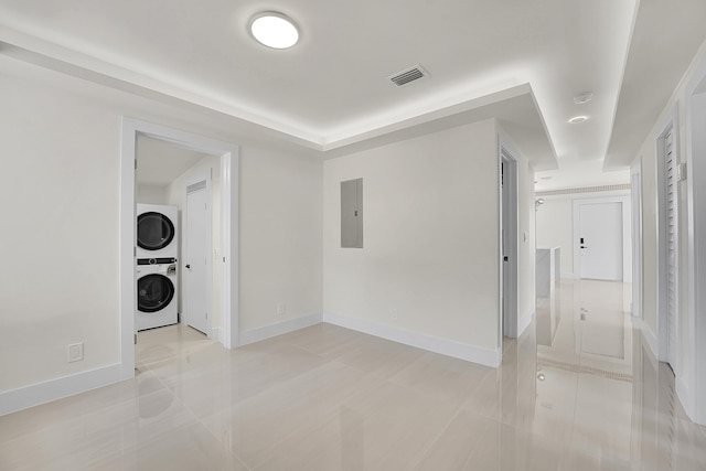 928 Market St, West Palm Beach, FL 33401 - spare room featuring visible vents, stacked washer and dryer, light tile patterned flooring, baseboards, and electric panel