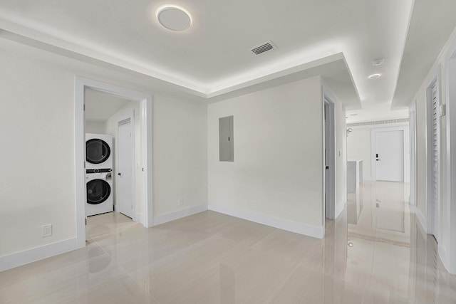 928 Market St, West Palm Beach, FL 33401 - spare room with visible vents, stacked washer and clothes dryer, light tile patterned flooring, baseboards, and electric panel