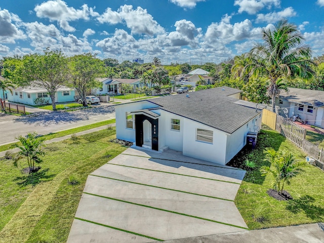 928 Market St, West Palm Beach, FL 33401 - single story home with roof with shingles, fence, a residential view, stucco siding, and concrete driveway