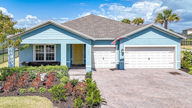 ranch-style home featuring a porch, driveway, roof with shingles, an attached garage, and stucco siding