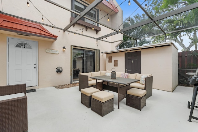 view of patio featuring outdoor dining space and glass enclosure