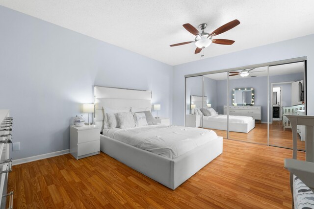 bedroom with baseboards, ceiling fan, wood finished floors, and a closet