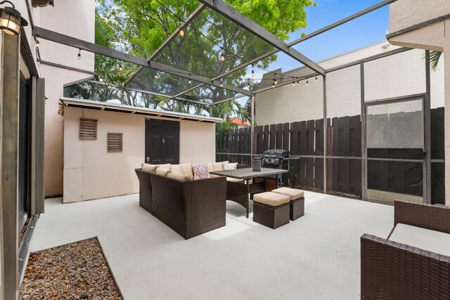 view of patio / terrace featuring fence, outdoor lounge area, and a grill
