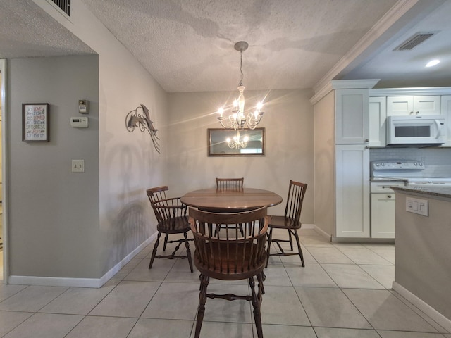 dining space with light tile patterned flooring, a notable chandelier, visible vents, and baseboards