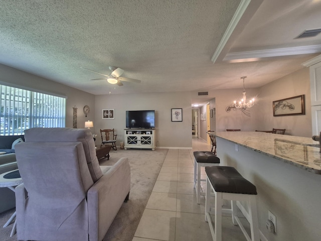 living room featuring visible vents, a textured ceiling, ceiling fan with notable chandelier, and light carpet
